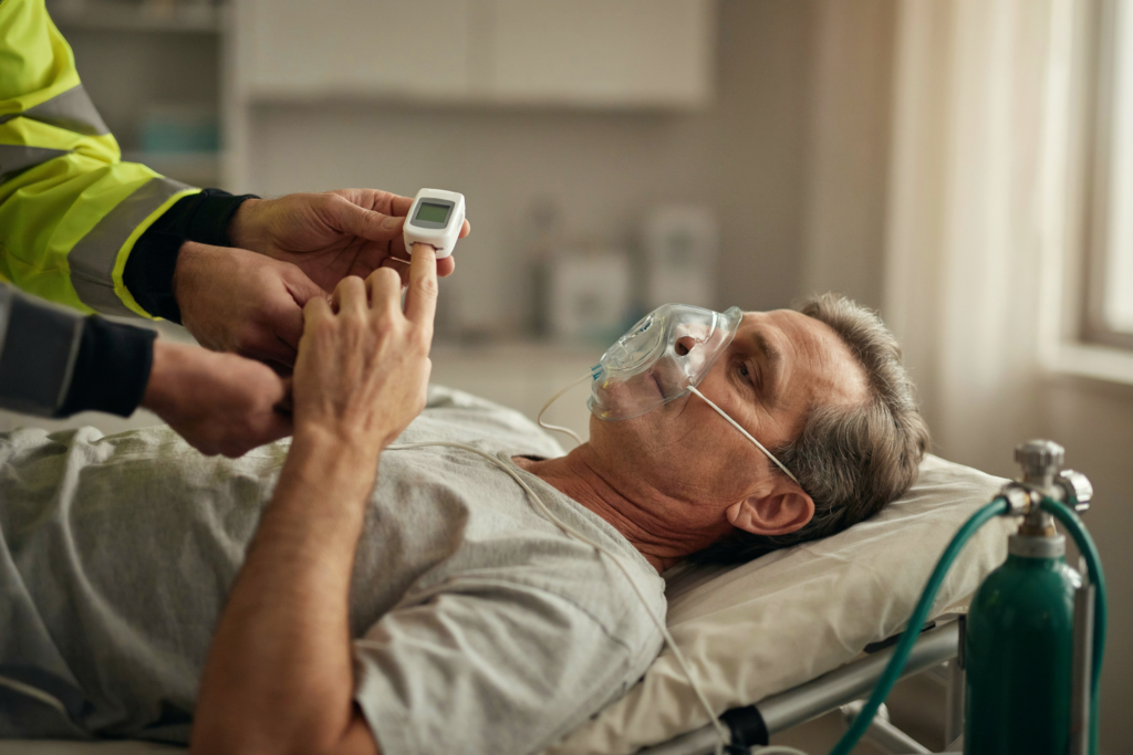 Pulse oximeter and oxygen mask on a casualty